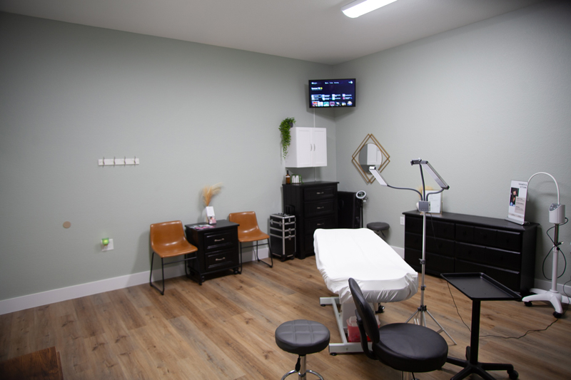 Esthetics treatment room at Hello Beautiful with a facial bed and steamer